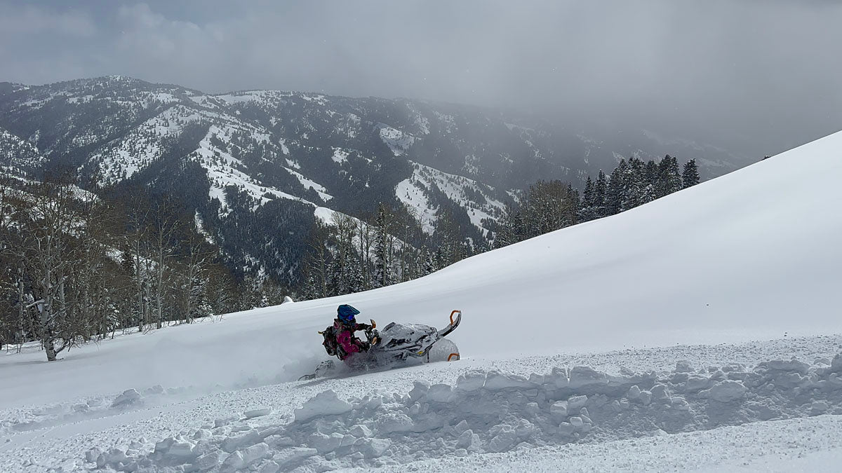 Backcountry snowmobile rider on Utah mountain trail near Park City