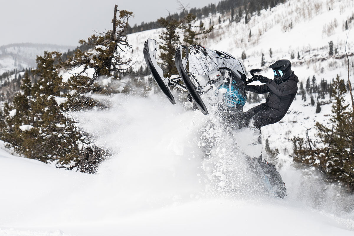 Backcountry snowmobile tour through deep powder near Park City, Utah