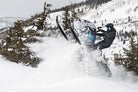 Backcountry snowmobile tour through deep powder near Park City, Utah