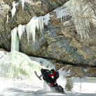 Snowmobiler riding deep powder in Park City, Utah backcountry