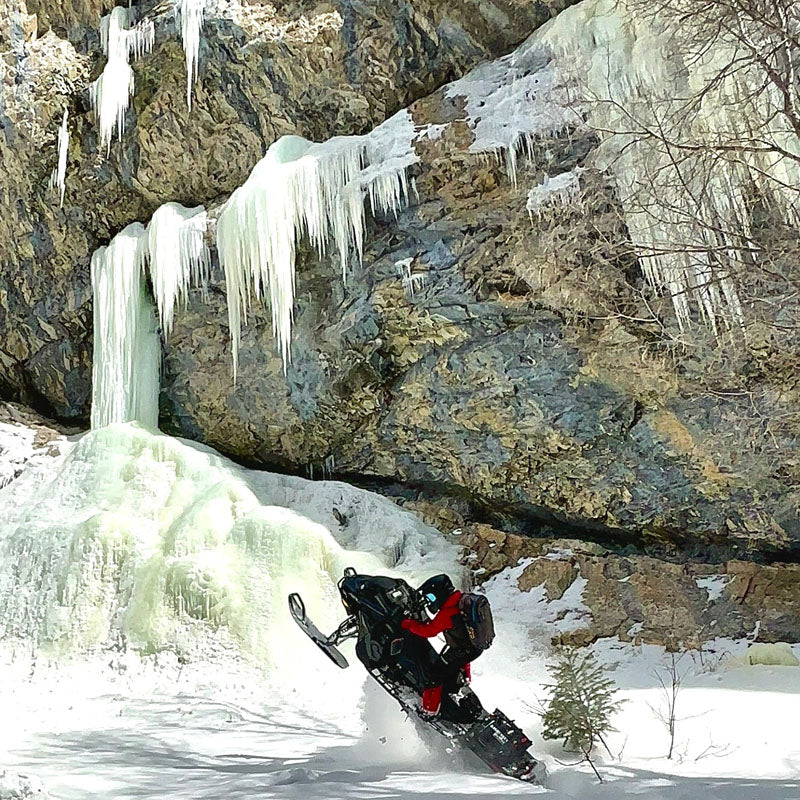 Snowmobiler riding deep powder in Park City, Utah backcountry