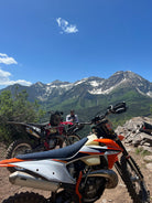 Dirt biker navigating singletrack trail in Northern Utah mountains