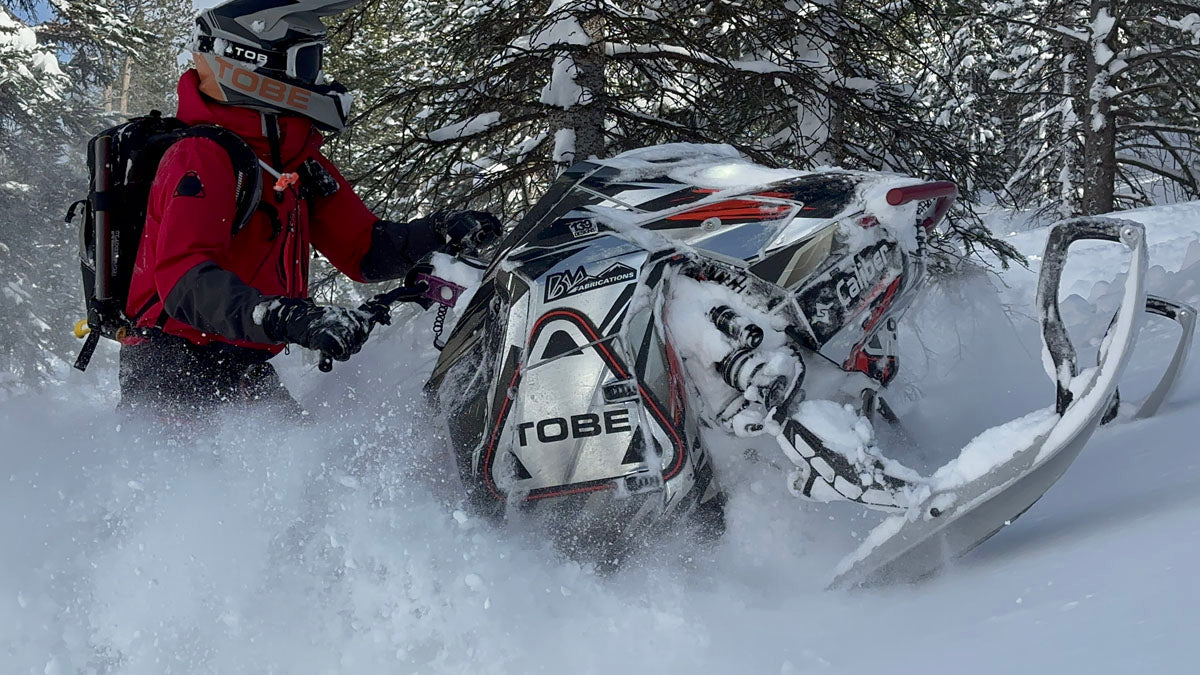 Snowmobile tour group exploring Utah backcountry terrain near Park City