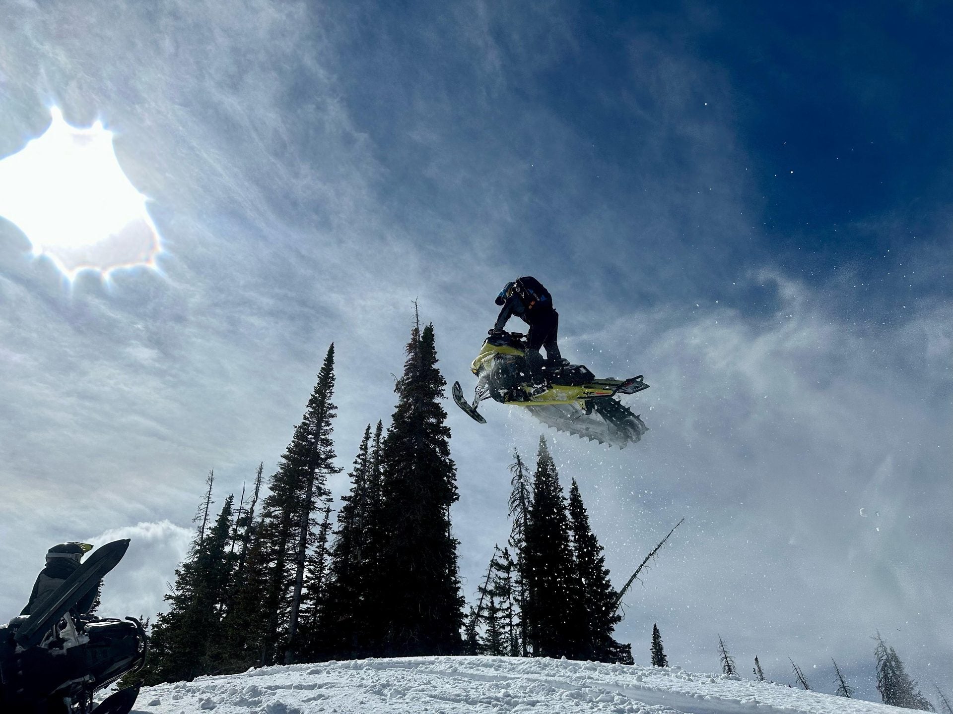 Backcountry snowmobile tour through deep powder near Park City, Utah