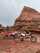 Moab dirt bike vacation — rider on red rock trail